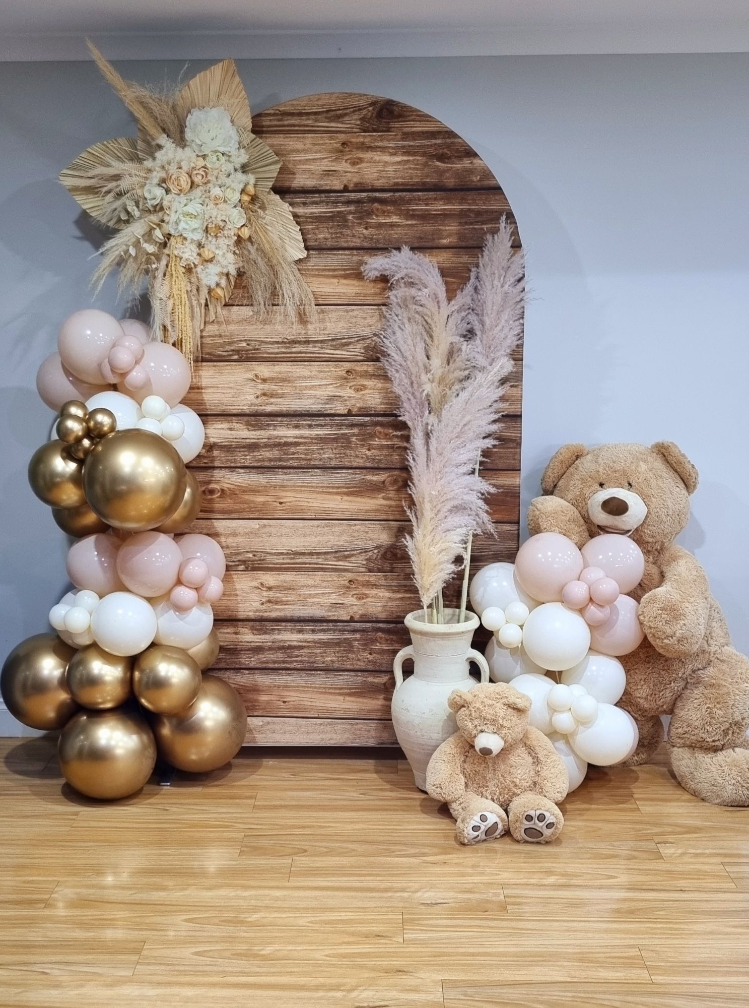 Wooden Arch backdrop
Artificial floral arrangement
Balloon Garland
Large and Medium Teddy Bear
Urn with Pampus grass
Delivery and styling within 40kms $400